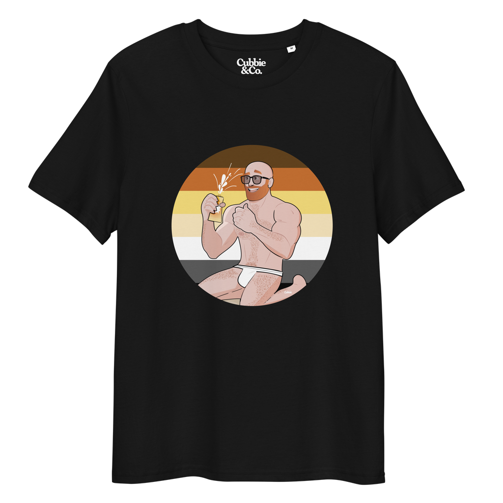 Black t-shirt featuring Aaron the beach bear posing in front of a Bear Pride Flag as suncream spurts over his tight budgie smugglers