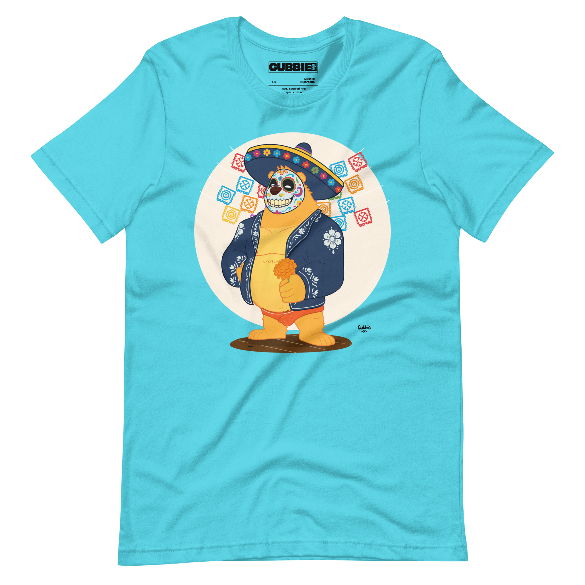 Turquoise t-shirt featuring a cartoon LGBTQ+ bear character celebrating Day of the Dead, wearing a sombrero and traditional Mexican clothing