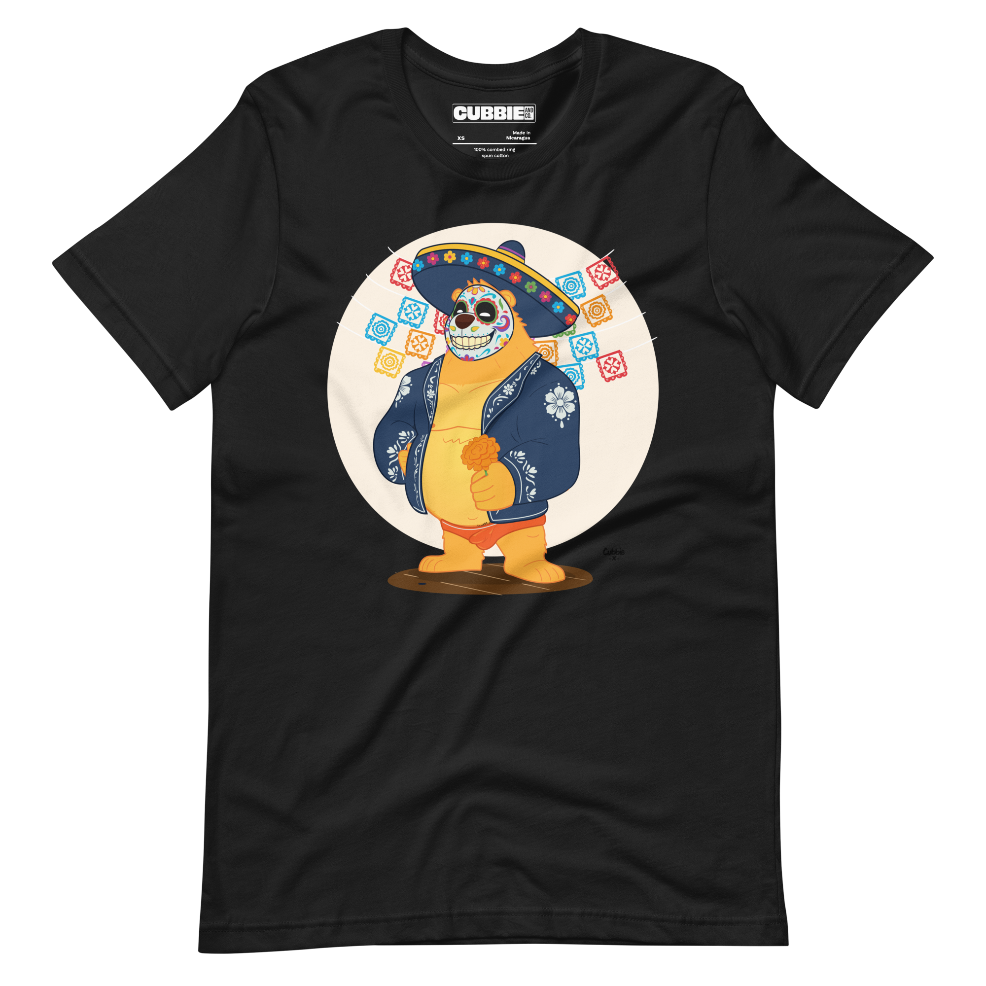 Faded black t-shirt featuring a cartoon LGBTQ+ bear character celebrating Day of the Dead, wearing a sombrero and traditional Mexican clothing
