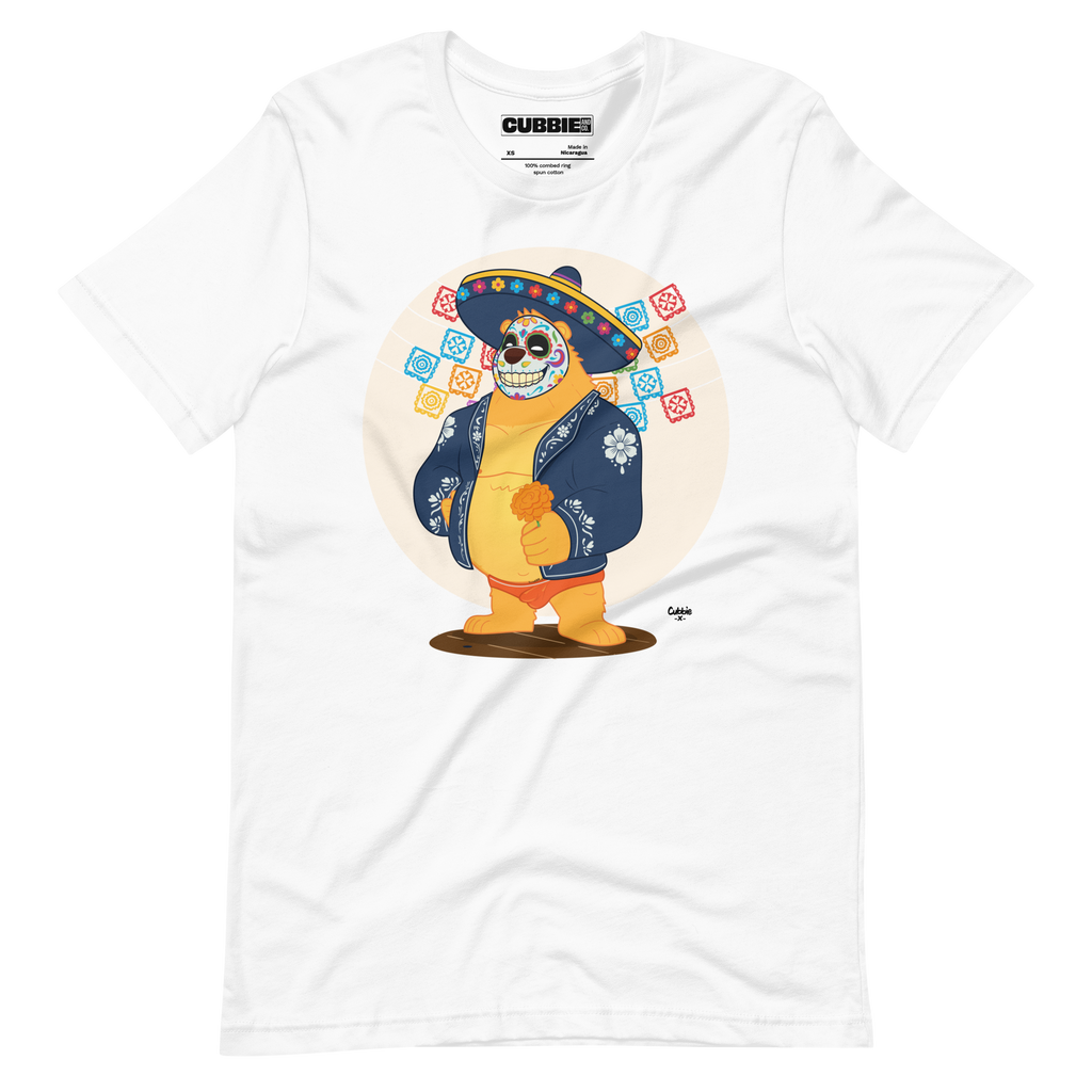 White t-shirt featuring a cartoon LGBTQ+ bear character celebrating Day of the Dead, wearing a sombrero and traditional Mexican clothing